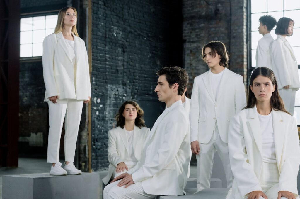 Your Fashion, your choice Stylish group fashion photo with models in white suits in an industrial setting.