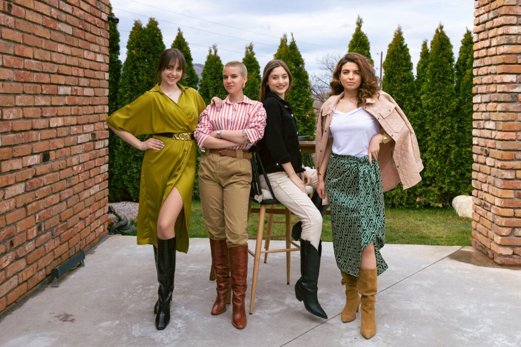 pexels photo 15984042 Four women showcasing unique outfits and boots, posing confidently outdoors.