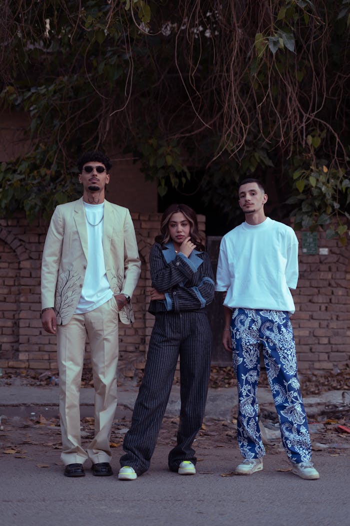 My Post Three fashionable adults posing confidently on a street in Baghdad.