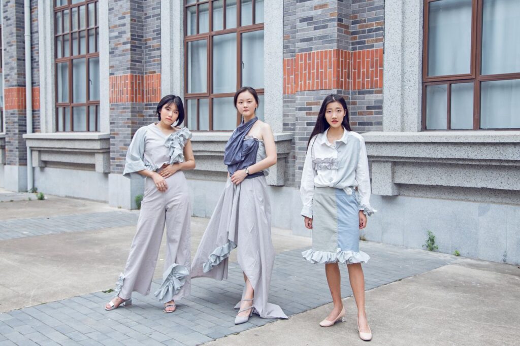 Your Fashion, your choice Three fashionable women pose confidently outdoors in stylish urban attire.
